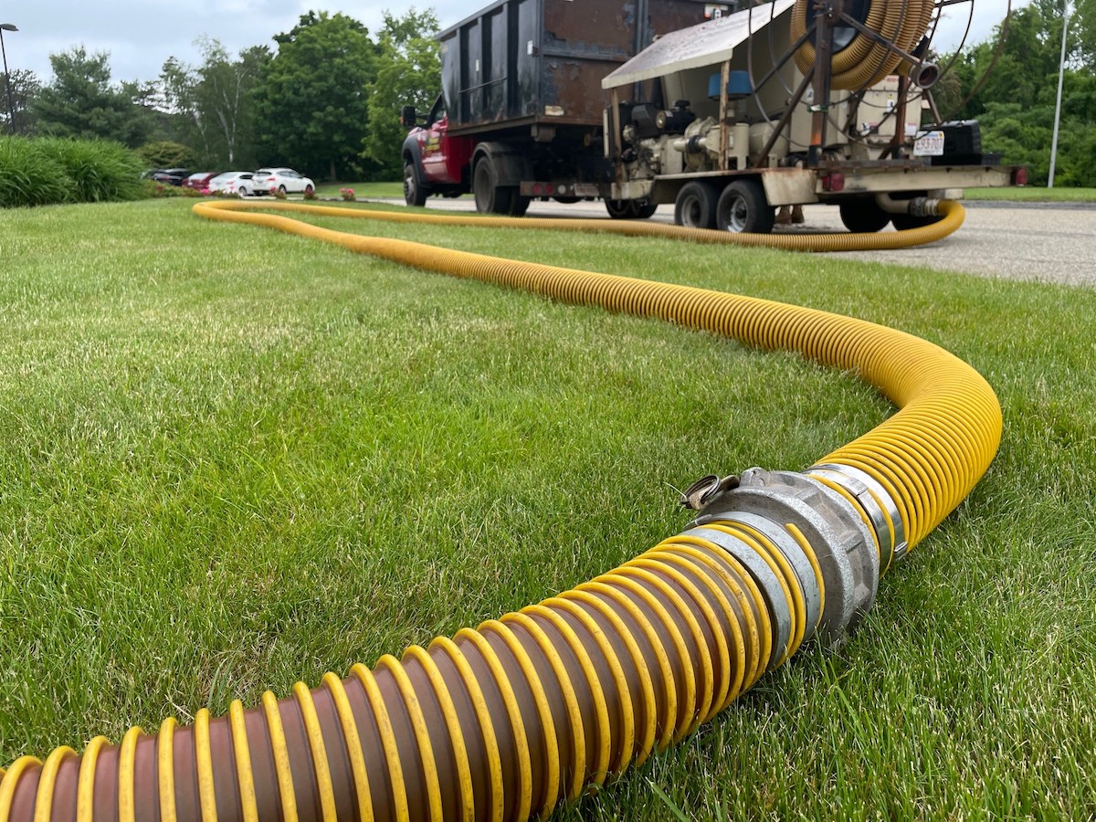 photo of mulch blower hose with truck in background